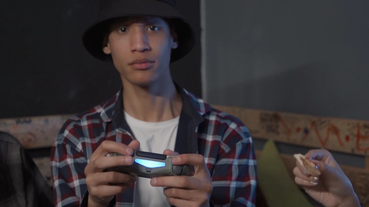 Happy Teenagers Playing Video Games Together While Eating Stock Video